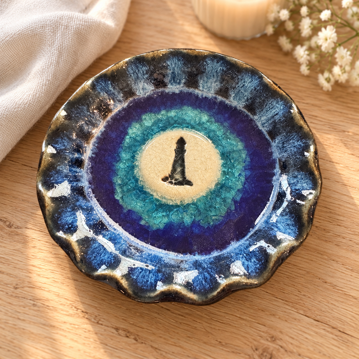 Blue lighthouse pottery trinket dish in a cozy farmhouse setting